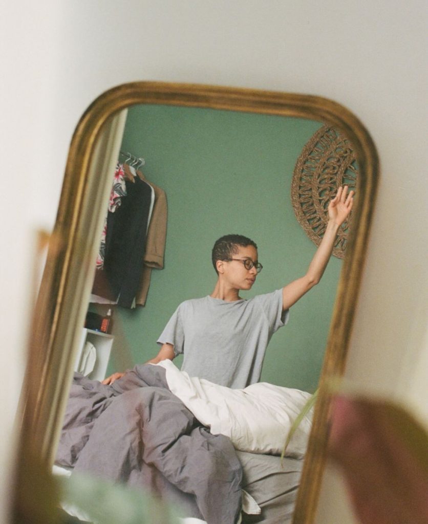 girl stretching in the mirror